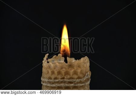 Burning Candle Against A Black Background With Free Copy Space For Text