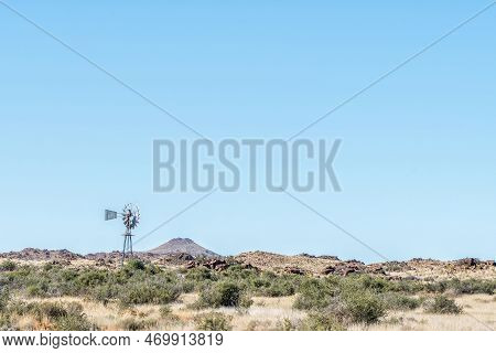 A Typical Karoo Landscape, With A Windmill And Hills, On Road R356 Between Loxton And Fraserburg In 