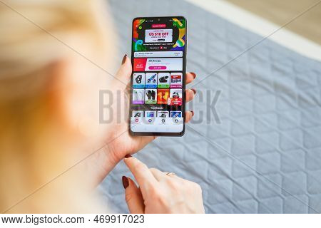 Kyiv, Ukraine - November 26, 2019: Woman Holding Phone With Internet Shopping Service Aliexpress On 
