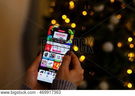 Kyiv, Ukraine - November 27, 2019: Woman Holding Phone With Internet Shopping Service Aliexpress On 