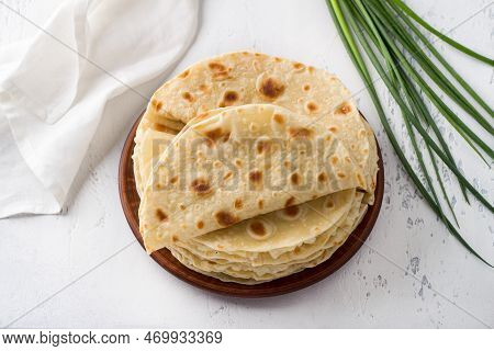 Traditional Tatar Flatbread, Kastyby And A Bunch Of Green Onions On A Light Gray Background, Top Vie