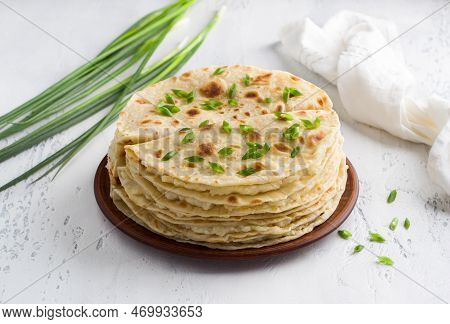 Traditional Tatar Flatbread, Kastyby And A Bunch Of Green Onions On A Light Gray Background