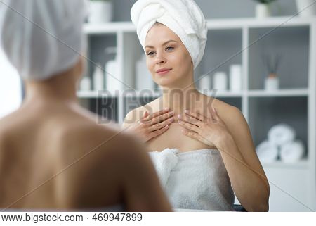 Young Woman Sits In The Bathroom In Front Of The Makeup Mirror And Does Cosmetic Procedures. Beautif