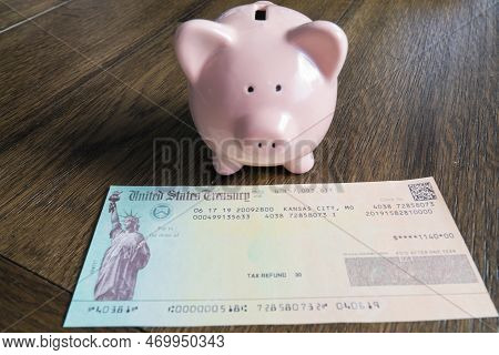 Tax Refund Check With Pink Piggy Bank