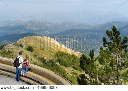 Preteen Boy And Father Admiring Of Amazing Aerial View Of Range Near Kotor Bay, Montenegro. Breathin