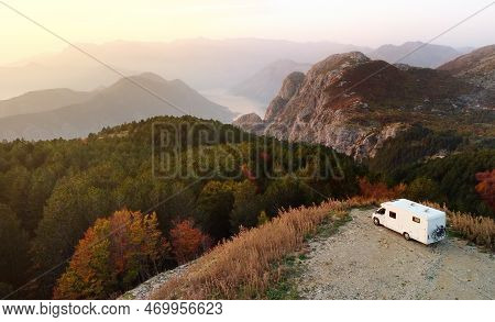 Drone Aerial View Of Parked Big Modern Camper Motorhome. Family Vacation Travel Rv. Bicycles Attache