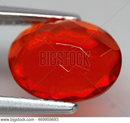 Natural Gemstone Fire Opal On Gray Background