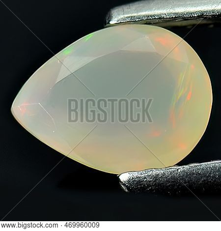 Natural Gemstone Rainbow Opal On Gray Background