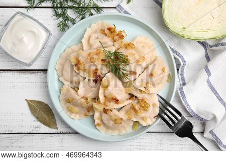 Cooked Dumplings (varenyky) With Tasty Filling, Fried Onions And Dill On Wooden Table, Flat Lay