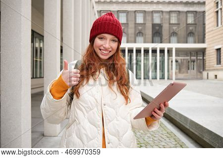 Stylish Ginger Girl, Tourist Walks With Digital Tablet Around City, Woman Connects To Iternet On Her
