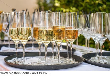 Outdoor Garden Scenery Showing Some Half Filled Sparkling Wine Glasses On A Tray