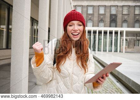 Stylish Ginger Girl, Tourist Walks With Digital Tablet Around City, Woman Connects To Iternet On Her