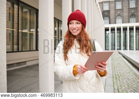 Stylish Ginger Girl, Tourist Walks With Digital Tablet Around City, Woman Connects To Iternet On Her