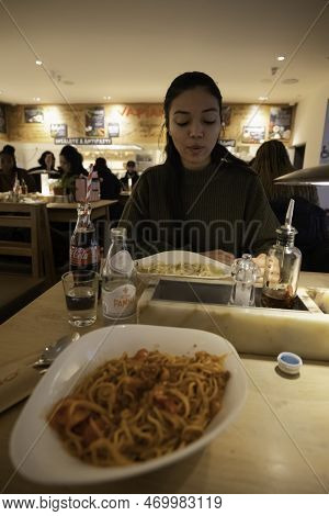 London - 02 27 2022: Woman Looking At Plate Of Satisfied Pasta