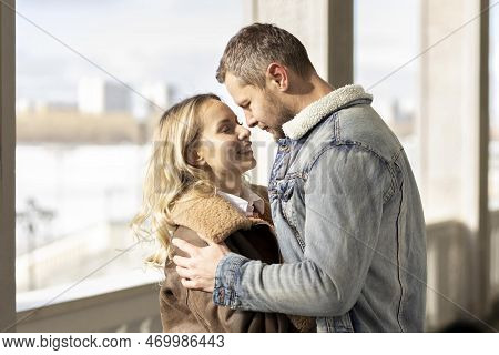 A Smiling Couple Is In Love Outdoors.a Young Happy Couple Embraces On A City Street.