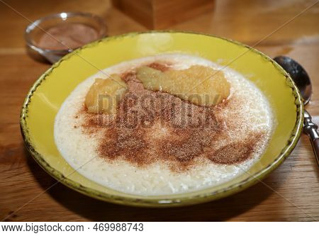 A Plate Of Porridge, Applesauce, And Cinnamon And Sugar.