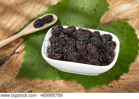 Healthy Food - Nuts Dehydrated Grapes; Photo On Wooden Background