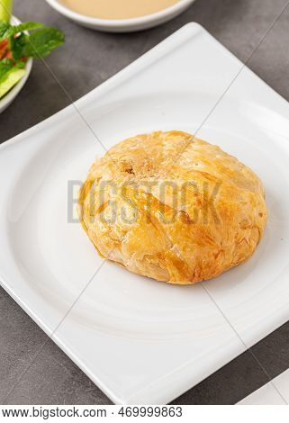 Izmir Boyoz On A White Porcelain Plate On A Stone Table