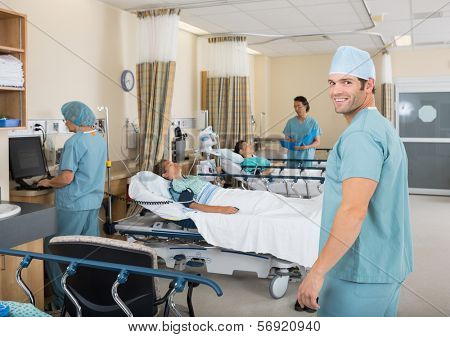 Portrait of young male nurse standing in hospital PAR unit