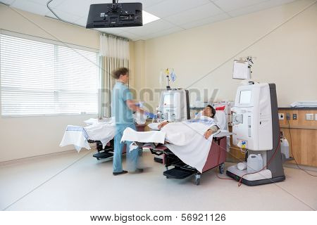 Blurred motion of nurse preparing patient for dialysis