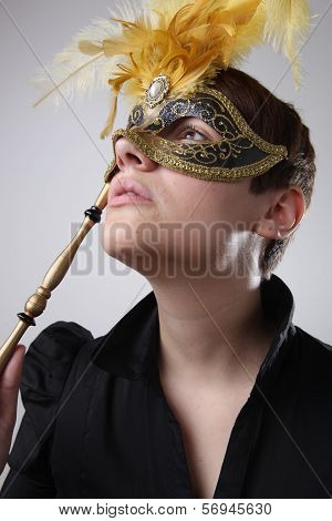 Elegant girl with a wonderful mask studio shot
