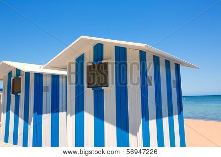 Beach houses in Alicante Denia blue and white stripes at Mediterranean sea of Spain