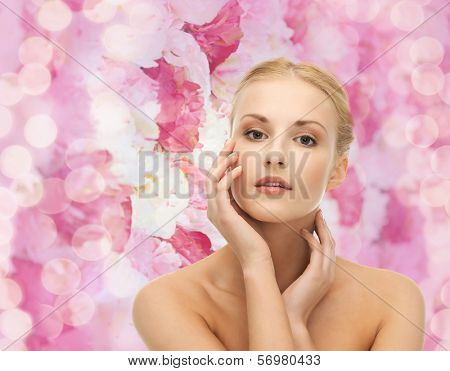portrait of beautiful woman touching her face skin