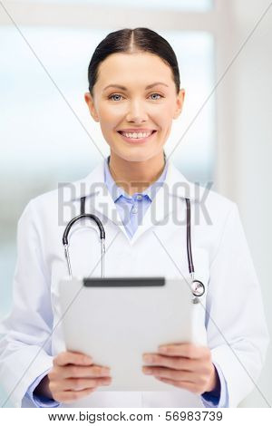 healthcare, technology and medicine concept - smiling young doctor with tablet pc computer and sthethoscope in cabinet