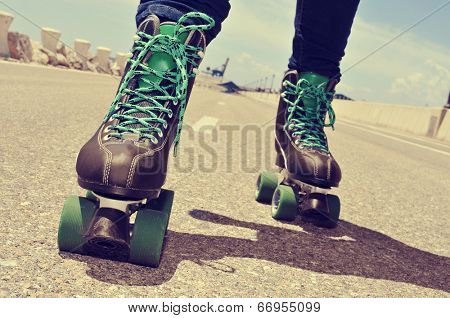 closeup of a young man roller skating, with a cross-processed effect