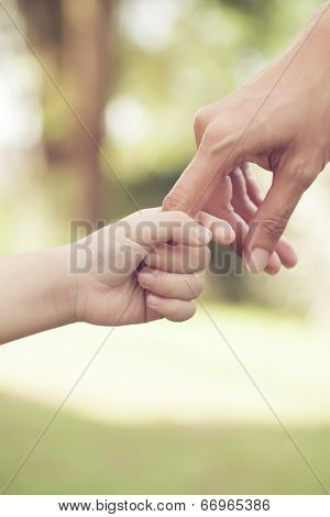 Mother and son holding hand