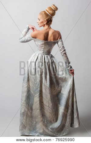 Old fashioned sexy woman in long dress with beautiful creative hairstyle