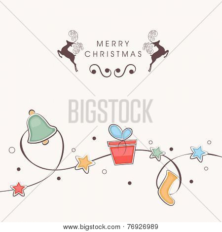 Beautiful ornaments tied with stars decorated rope on beige background for Merry Christmas celebrations.