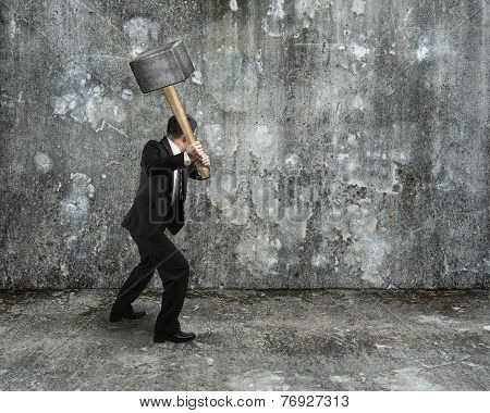 Businessman Hold Sledgehammer To Crack Old Mottled Concrete Wall