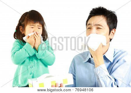 sneezing father and daughter