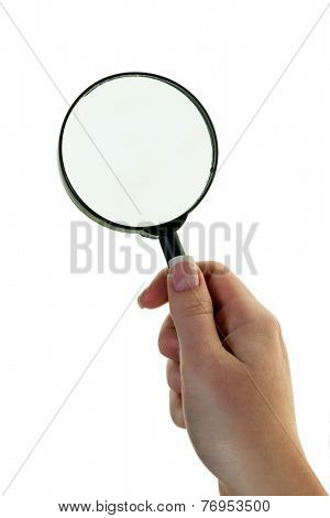 a hand holding a magnifying glass. viewed through the magnifying glass.