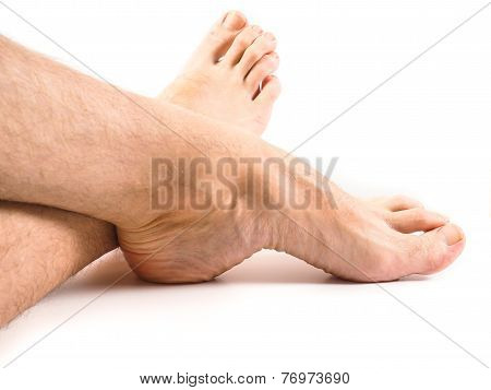 Hairy Legs And Feet Of Male Person Resting Towards White Background