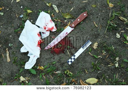 Bloody knife dragged along outdoors