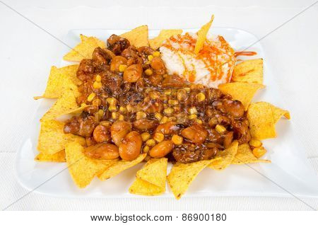Dish of chips, beans, corn and rice.