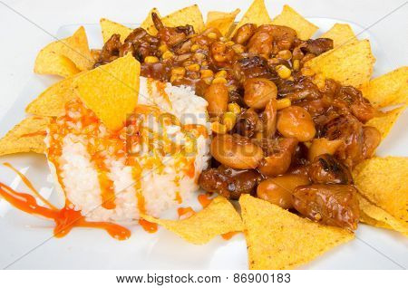 Dish of chips, beans, corn and rice.