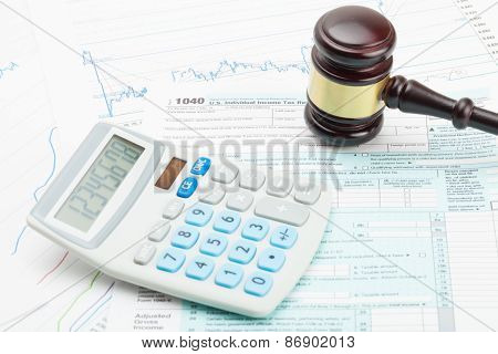 Wooden Judge's Gavel And Calculator Over Some Financial Documents