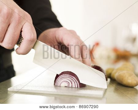 Close up of a man Cutting onion with knife