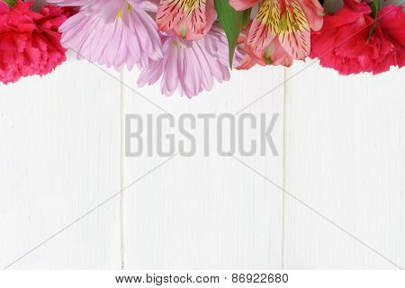 Flower top border on white wood