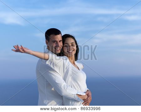 happy young romantic couple have fun relax smile at modern home outdoor terace balcony terace