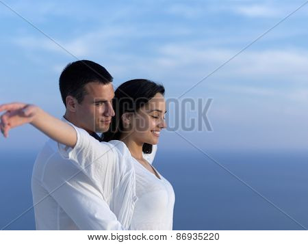 happy young romantic couple have fun relax smile at modern home outdoor terace balcony terace