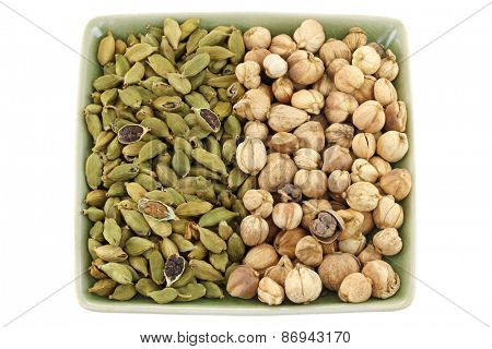 Dried green Cardamon pods and Round Siamese Cardamom (Camphor Seed) isolated on white
