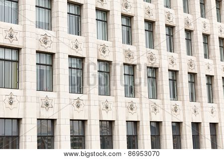 A cropped view of a beige stone cladding building