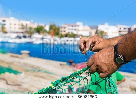 Majorca Cala Ratjada beach Rajada fisherman sewing fishing net