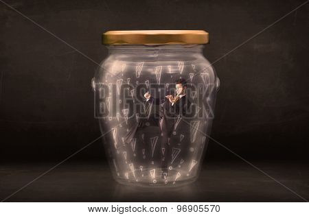 Business man trapped in jar with exclamation marks concept on bakcground