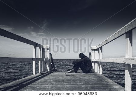 Alone Young Man At The Edge Of Wooden Pier
