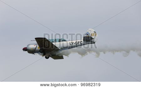 Thiene, Vicenza - Italy. 26Th July, 2015: Aircraft With Two Pilots And Smoke